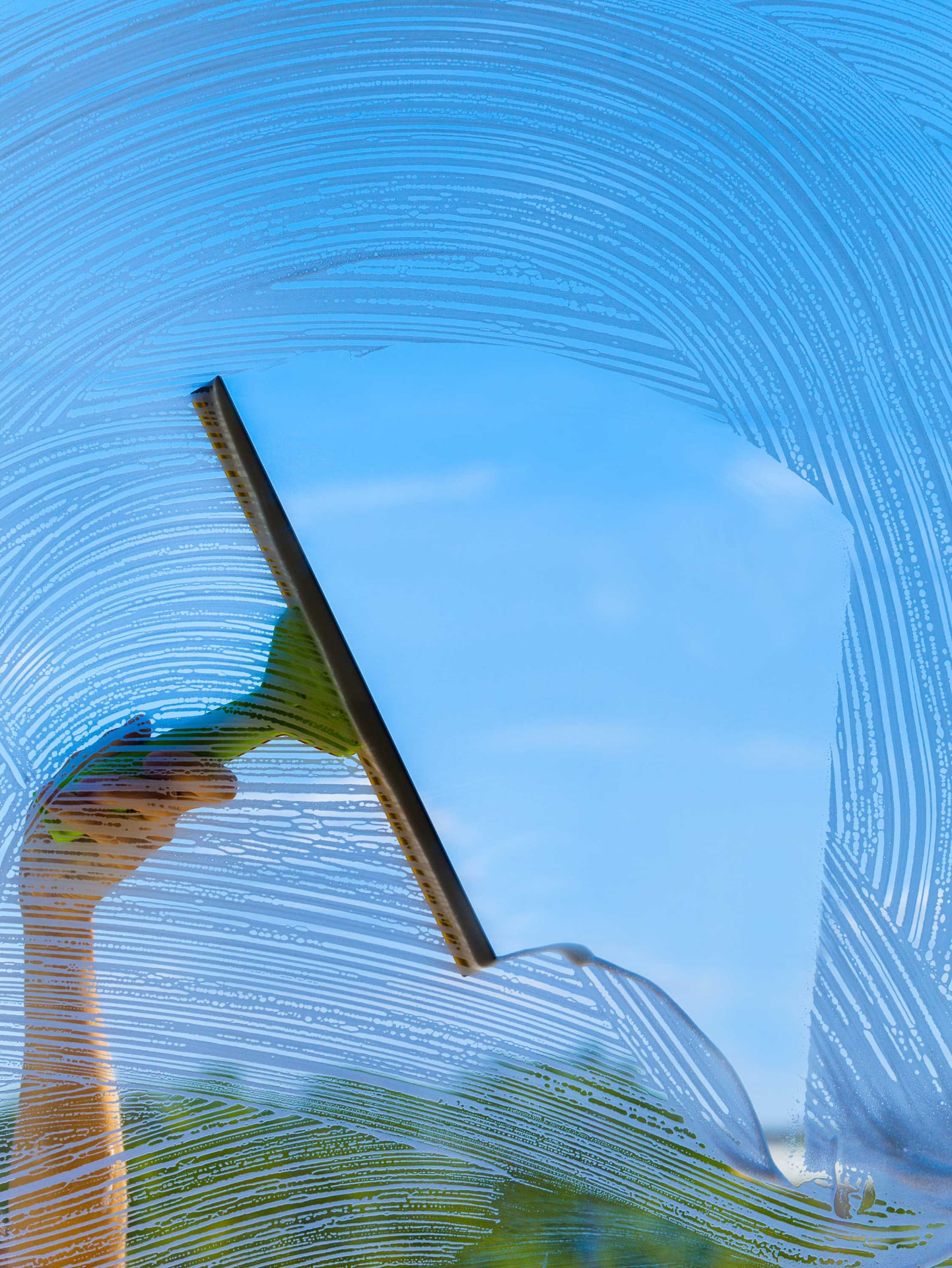 Window being cleaned with a squeegee